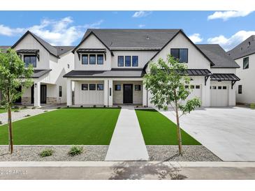 Charming new construction home with a manicured lawn, long driveway, and a three car garage at 26643 S 169Th Pl, Queen Creek, AZ 85142