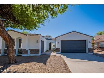 Charming single-story home with a well-maintained front yard and a two-car garage at 2991 E Folley Pl, Chandler, AZ 85225