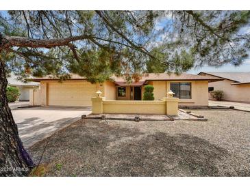Charming single-story home with a well-maintained front yard and a two car garage at 9645 W Kimberly Way, Peoria, AZ 85382