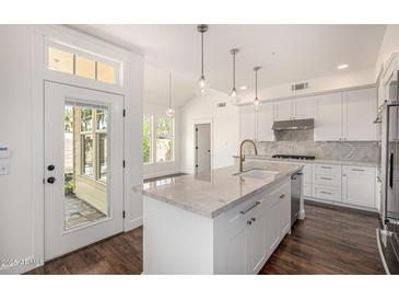 Bright kitchen with white cabinets, granite countertops, and a stainless steel sink and appliances at 122 W Cottage Ln, Tempe, AZ 85282