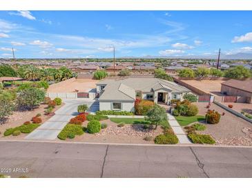 Stunning home boasts a desert-landscaped front yard, long driveway, and a charming façade at 5586 W Rock Ct, San Tan Valley, AZ 85144