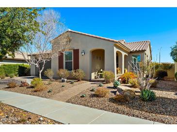 Attractive desert home with tidy front landscaping and covered front porch and beautiful plants at 5742 S Winchester St, Mesa, AZ 85212