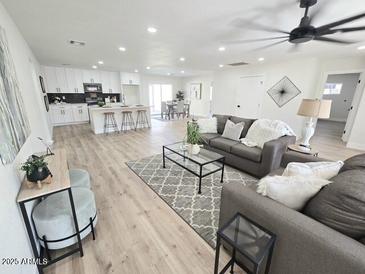 Spacious living room with hardwood floors, ceiling fan, and comfortable seating area at 6607 S Mitchell Dr, Tempe, AZ 85283