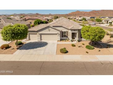 Beautiful single-story home featuring a well manicured xeriscaped front yard and a spacious three car garage at 13806 W Remuda Dr, Peoria, AZ 85383