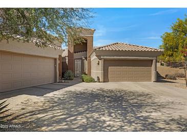Charming single-story home with a three-car garage, beautiful landscaping, and a tile roof on a sunny day at 16450 E Avenue Of The Fountain -- # 47, Fountain Hills, AZ 85268