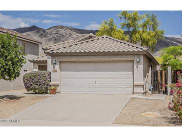 Charming home featuring a two-car garage, desert landscaping, and mountain views in a desirable location at 1744 W Brookwood Ct, Phoenix, AZ 85045