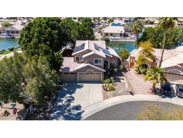 Beautiful two-story home with a three-car garage, desert landscaping and solar panels, all on a picturesque waterfront lot at 20410 N 51St Dr, Glendale, AZ 85308
