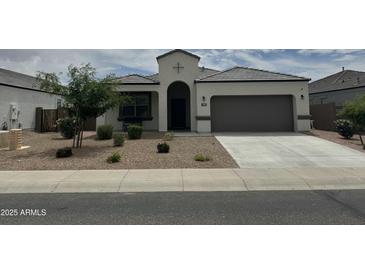 Charming single-story home featuring a two-car garage and desert landscaping at 30395 W Mitchell Ave, Buckeye, AZ 85396