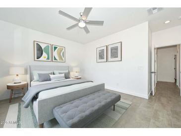 Serene bedroom featuring a comfortable bed, stylish decor, and ample natural light at 32017 N Redding St, Wittmann, AZ 85361