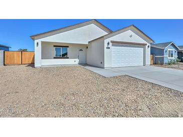 Charming single-story home with a well-maintained facade, two-car garage and desert landscaping at 32017 N Redding St, Wittmann, AZ 85361