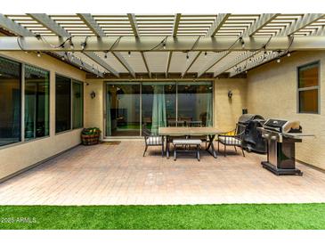 Outdoor patio area with a pergola, grill, and dining set, perfect for entertaining at 4495 E Woodside Way, Gilbert, AZ 85297