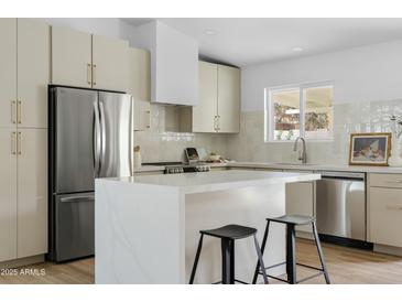 Well-equipped kitchen featuring a stainless steel refrigerator, and a functional island at 6351 E Waltann Ln, Scottsdale, AZ 85254