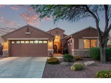 Charming single-story home with a well-manicured front yard and a two-car garage at dusk at 766 E Taylor Trl, San Tan Valley, AZ 85143