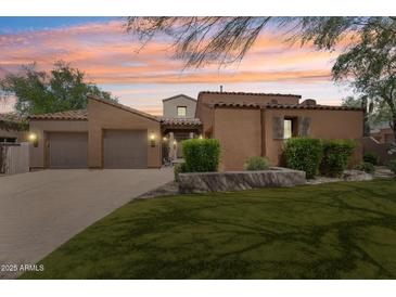 Charming single-story home featuring a well-manicured front yard, terracotta roof, and two-car garage at 8512 E Gilded Perch Dr, Scottsdale, AZ 85255