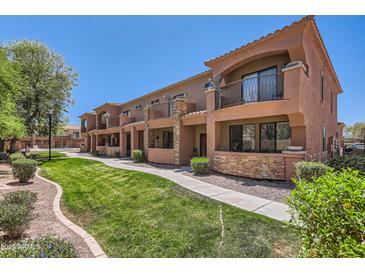 Inviting condo exterior with well-maintained landscaping, stone accents, and private balconies at 21655 N 36Th Ave # 121, Glendale, AZ 85308