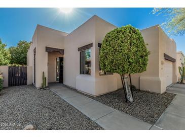 Front entrance and walkway with desert landscaping including cacti and decorative trees at 15148 N 100Th Pl, Scottsdale, AZ 85260