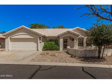 Charming single-story home featuring low-maintenance landscaping and an attached two-car garage at 15460 W Amelia Dr, Goodyear, AZ 85395