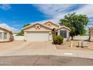Charming single-story home featuring a two-car garage, desert landscaping, and a welcoming facade at 16642 N 35Th Way, Phoenix, AZ 85032