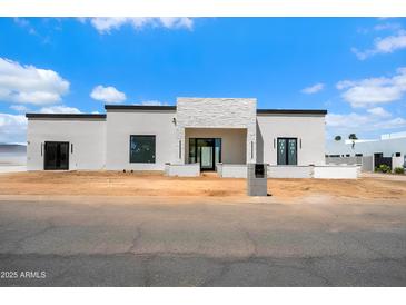Modern home with white stone accents, black trim, and minimalist design at 6202 E Larkspur Dr, Scottsdale, AZ 85254