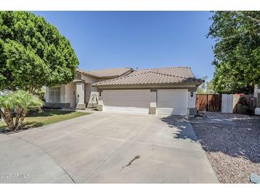 Charming single story home featuring a three car garage and desert landscaping at 1001 N Quail Ln, Gilbert, AZ 85233