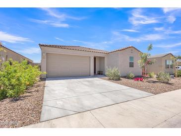 Charming single-story home with a well-manicured front yard and two car garage under a clear blue sky at 18501 E Donato Dr, Gold Canyon, AZ 85118