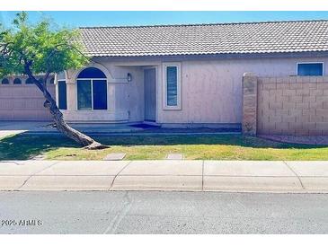 Charming single-story home with well-maintained landscaping and a unique tree in the front yard at 2221 E Union Hills Dr # 157, Phoenix, AZ 85024