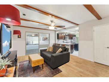 Comfortable living space with hardwood floors and an open concept to the kitchen at 4008 W Citrus Way, Phoenix, AZ 85019