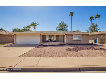 Charming single-story home with a well-maintained desert landscape and a spacious two-car garage at 720 S Rosemont --, Mesa, AZ 85206