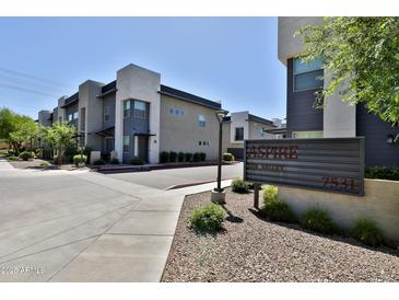 View of modern townhomes with gray and white exteriors and a sign for Aspire Sun Valley community at 7531 E Billings St # 131, Mesa, AZ 85207