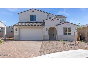 Charming two-story home with a well-manicured front yard and a two-car garage at 8865 W Orange Dr, Glendale, AZ 85305