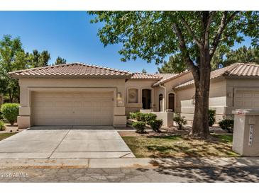 Charming single-story home features a well-manicured lawn and a two-car garage at 9649 E Holiday Way, Sun Lakes, AZ 85248