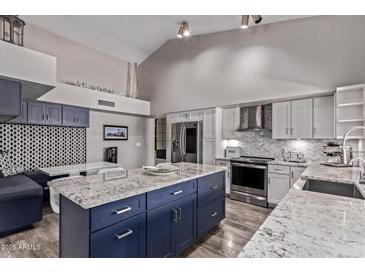 Stylish kitchen with a large island, stainless steel appliances, and a breakfast nook at 9736 E Ironwood Dr, Scottsdale, AZ 85258