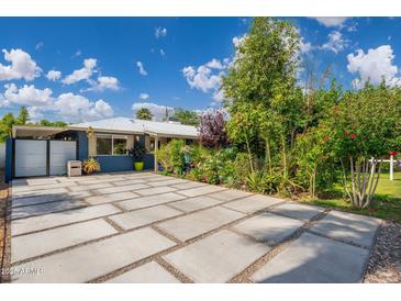 Paver driveway with lush plantings and a blue exterior at 2219 W Catalina Dr, Phoenix, AZ 85015