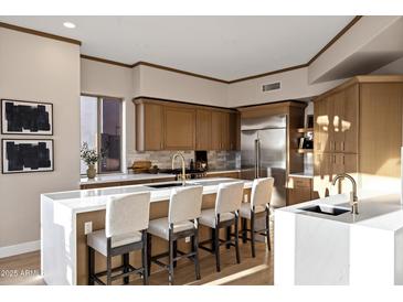 Gourmet kitchen featuring a large island with seating, modern cabinets, and stainless steel appliances at 18401 N 14Th St, Phoenix, AZ 85022