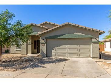 Charming single-story home featuring a two-car garage, desert landscaping, and a welcoming front entrance at 2122 W Alta Vista Rd, Phoenix, AZ 85041