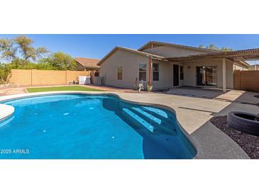 View of the pool and backyard with steps leading into the cool, refreshing water at 2122 W Alta Vista Rd, Phoenix, AZ 85041