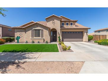 Charming single-Gathering home with a well-manicured lawn and a two-car garage at 21918 E Maya Rd, Queen Creek, AZ 85142