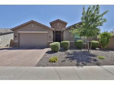 Charming single-story home featuring a brick driveway and desert landscaping at 2221 W Madisen Marie Ave, Queen Creek, AZ 85144