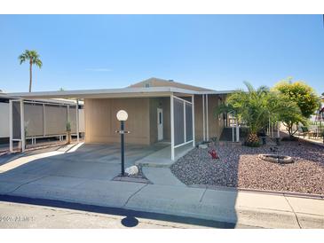 Charming manufactured home with covered parking, mature landscaping and a cozy front patio at 2233 E Behrend Dr # 84, Phoenix, AZ 85024
