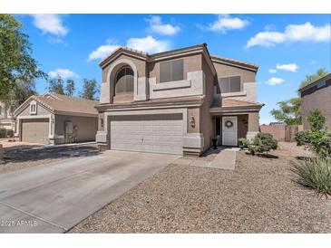 Charming two-story home featuring a two-car garage and low maintenance landscaping with ample parking at 2412 W Camp River Rd, San Tan Valley, AZ 85144