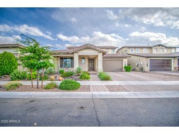 Charming single-story home showcasing desert landscaping, a two-car garage, and inviting curb appeal at 3879 E Harrison St, Gilbert, AZ 85295