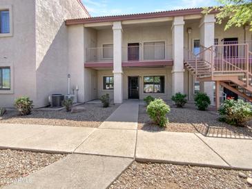 Inviting two-story condo complex with well-maintained landscaping and walkways, perfect for comfortable living at 1440 N Idaho Rd # 1048, Apache Junction, AZ 85119