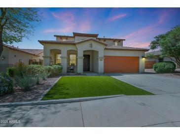 Beautiful stucco two-story home featuring a two-car garage and a well-manicured yard under a stunning sky at 29706 N 127Th Ln, Peoria, AZ 85383