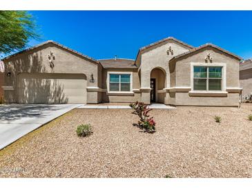 Charming single-story home featuring desert landscaping, a two-car garage, and a welcoming front entryway at 30208 W Fairmount Ave, Buckeye, AZ 85396