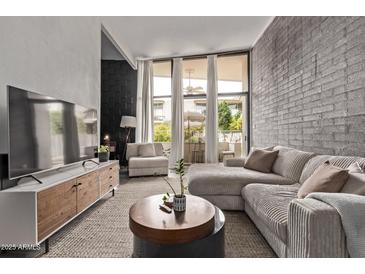 Cozy living room with large windows offering natural light and comfortable modern furnishings at 334 W Medlock Dr # D102, Phoenix, AZ 85013