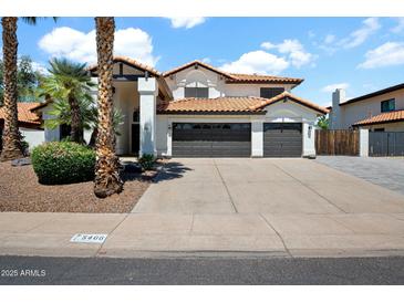 Charming two-story home featuring a three-car garage, well-maintained landscaping, and a classic tile roof at 5406 E Charleston Ave, Scottsdale, AZ 85254