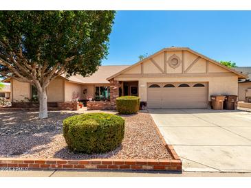 Charming single-Gathering home featuring a well-manicured front yard and a two-car garage at 7515 W Sweetwater Ave, Peoria, AZ 85381