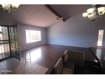 Bright living room features vaulted ceilings, hardwood floors, and large windows at 8310 N 49Th Ave, Glendale, AZ 85302
