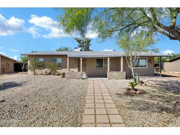 Charming single-story home featuring desert landscaping and a welcoming front porch at 9522 E Quarterline Rd, Mesa, AZ 85207