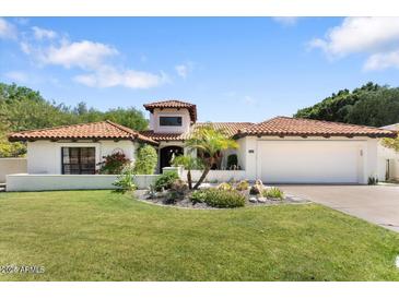 Charming single-story home with a red tile roof, lush lawn, and a well-manicured desert landscape at 3117 E Maryland Ave, Phoenix, AZ 85016